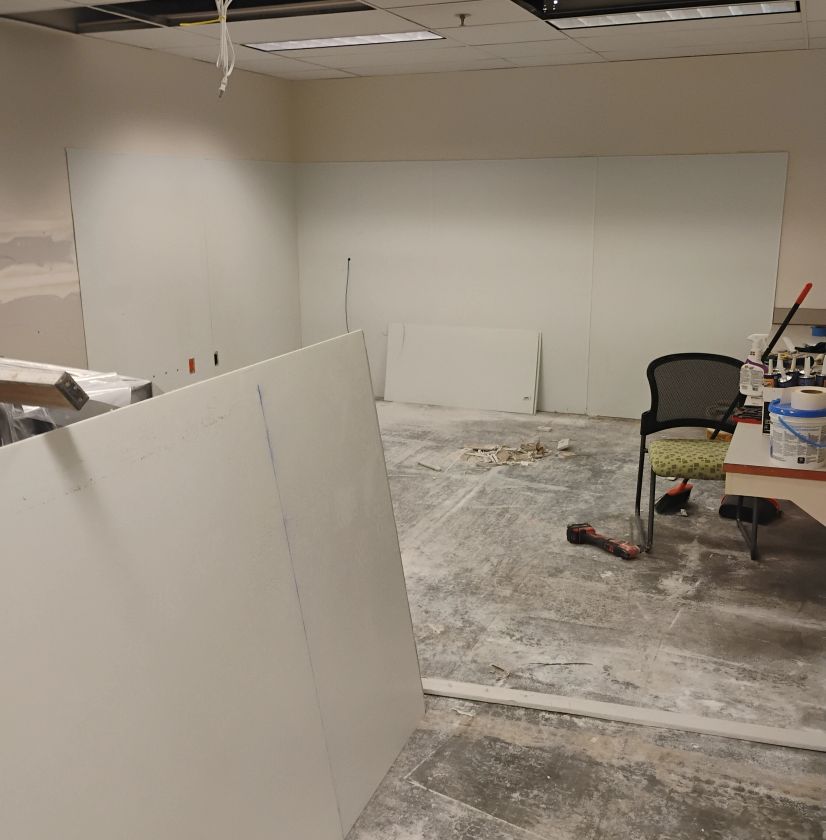 Basement renovation with exposed ceiling and partition walls