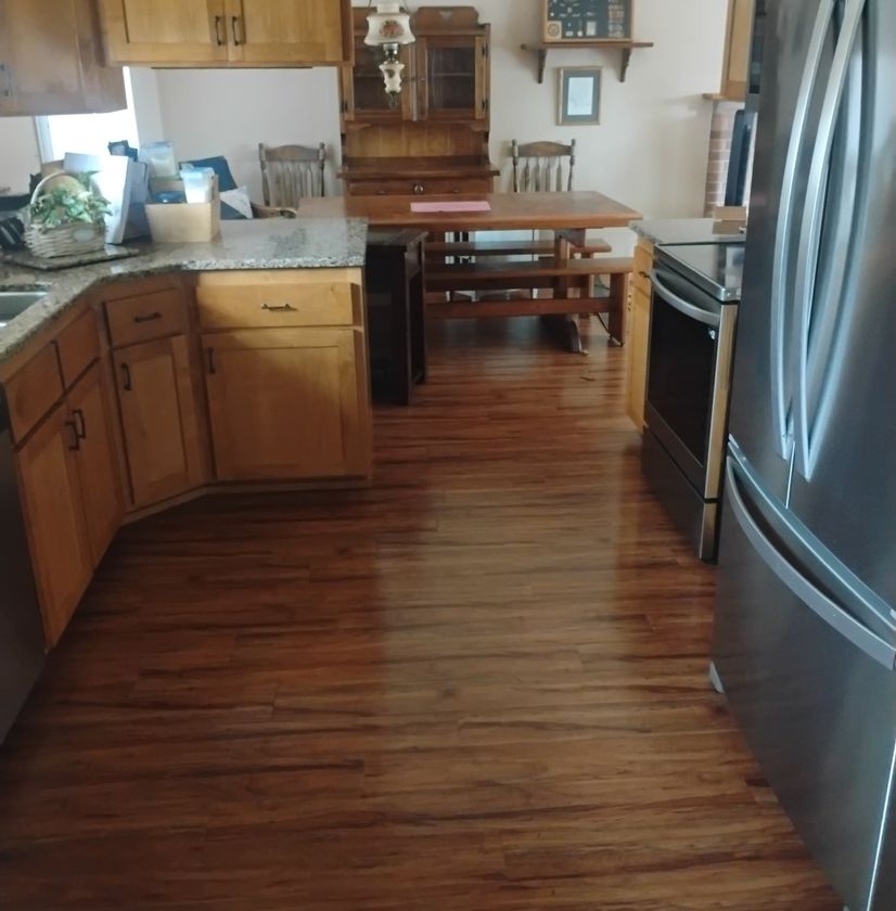 Renovated interior hallway and kitchen with wood flooring