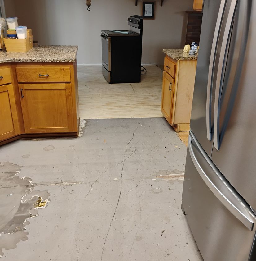 Kitchen remodeling work with unfinished flooring and cabinets