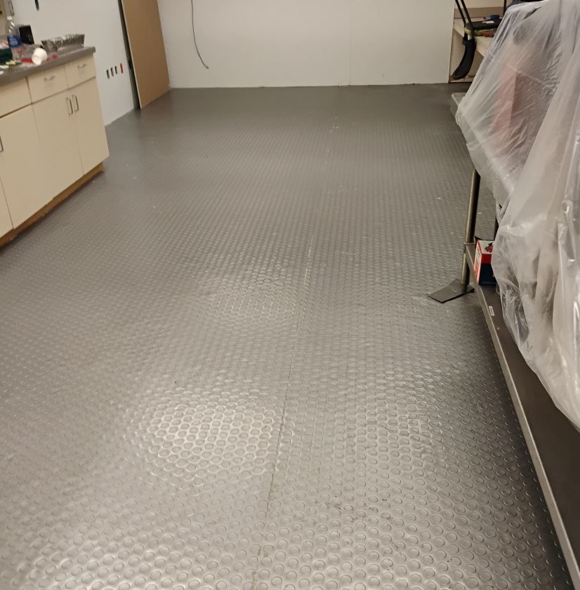 Finished basement floor with light-colored textured coating